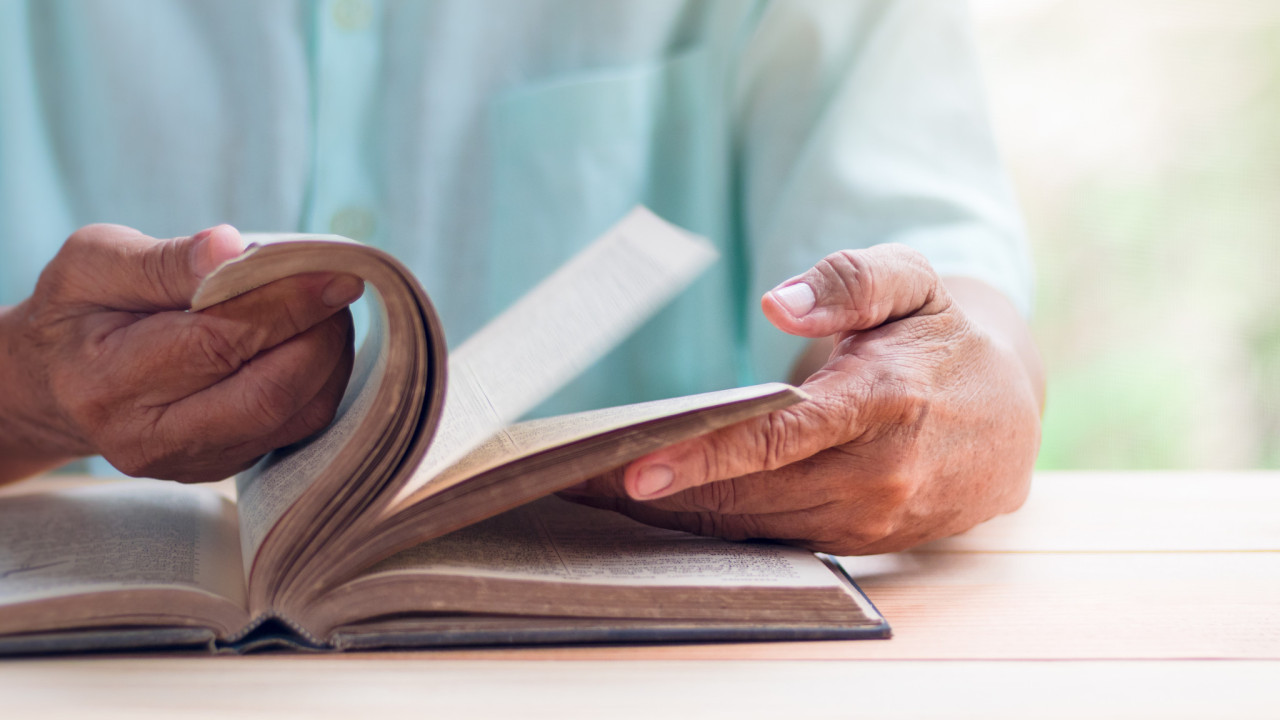 elder reading shutterstock 724445584